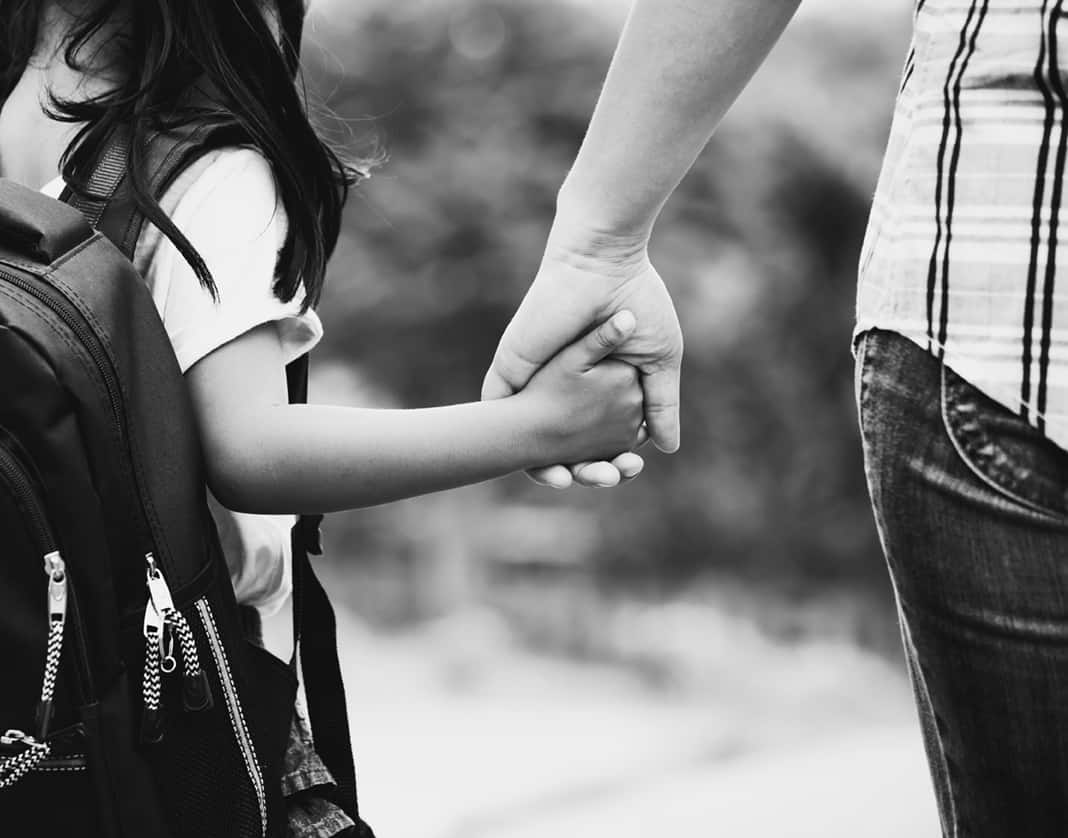 mom and daughter holding hands