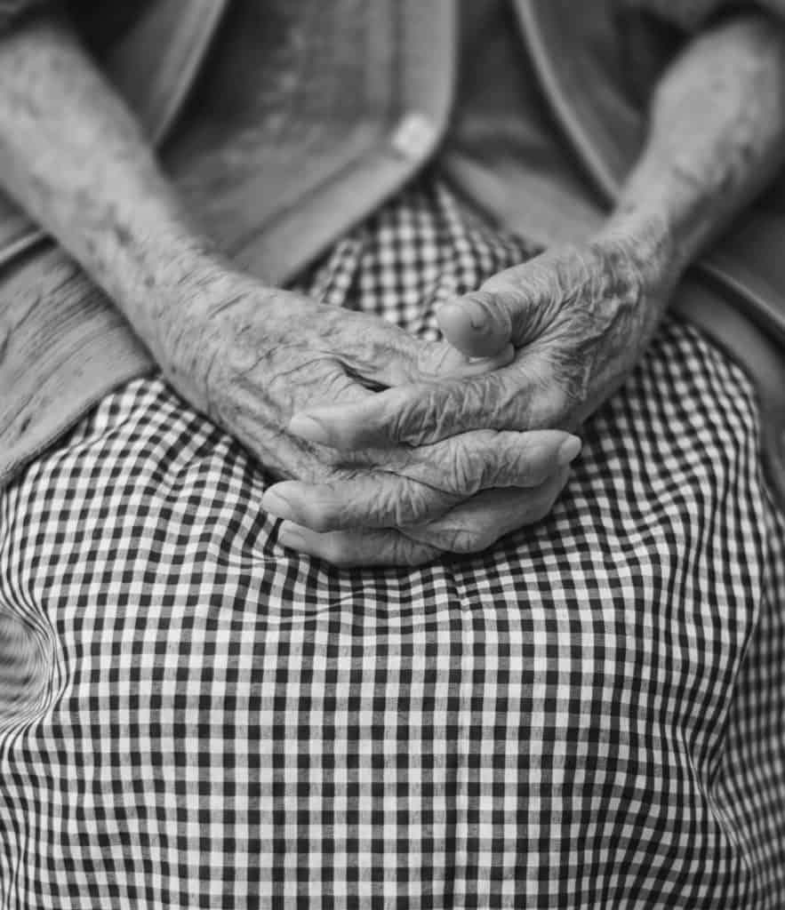 Elderly woman's hands in lap