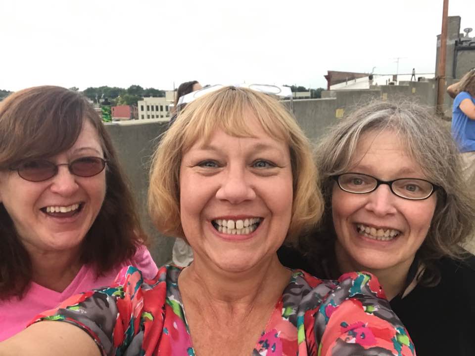 Irene (left) celebrates with KHRC colleagues during a rooftop event.