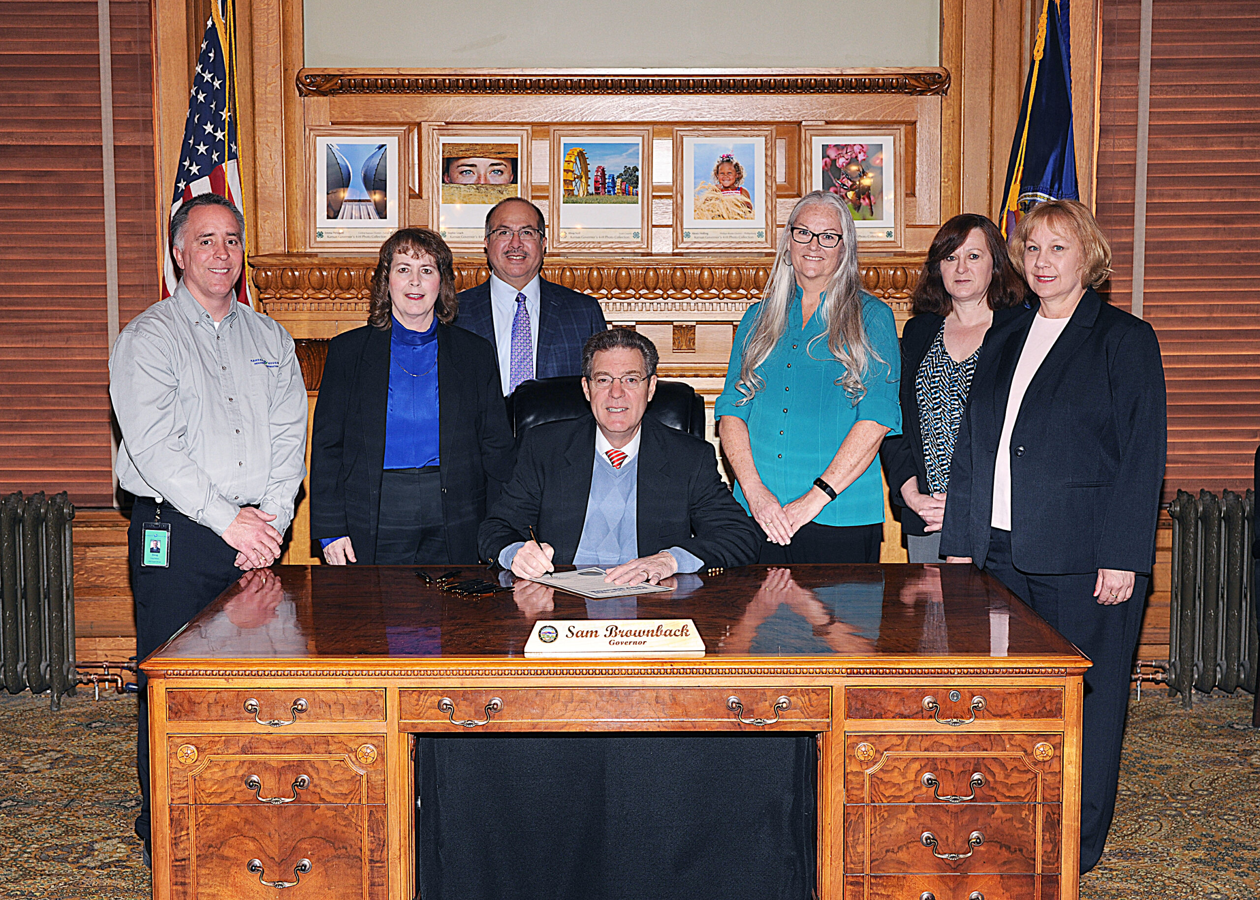 KHRC Staff meet with Gov. Sam Brownback during a 2017 Fair Housing Month proclamation signing. Irene is pictured second from the right.