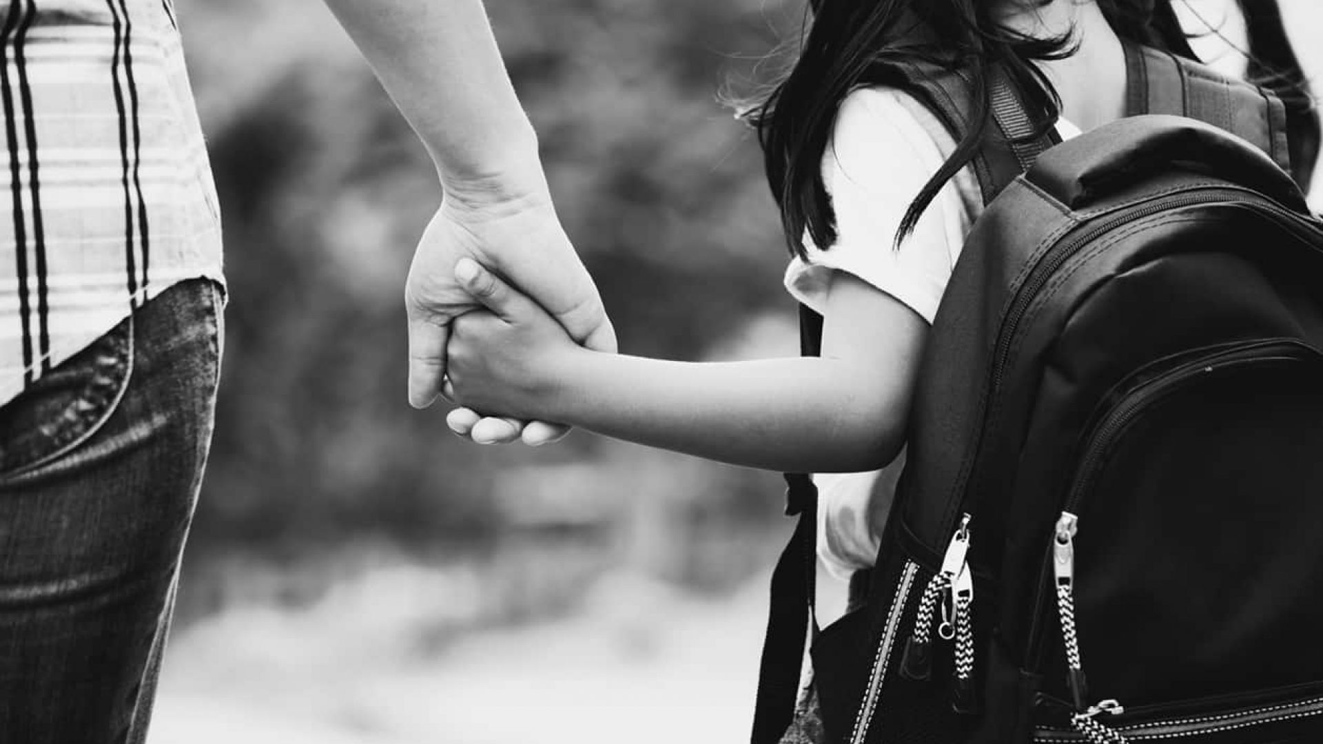 Back to school. Cute asian pupil girl with backpack holding her mom and daughter holding hands