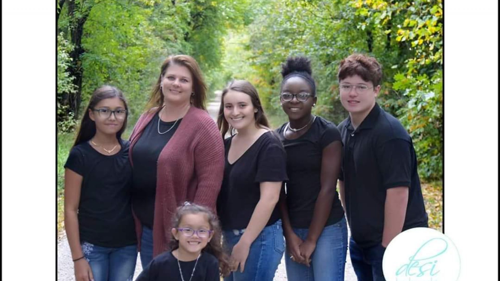 FB_IMG_1591667836295 Nicole Taylor and her children stand on a wooded road.