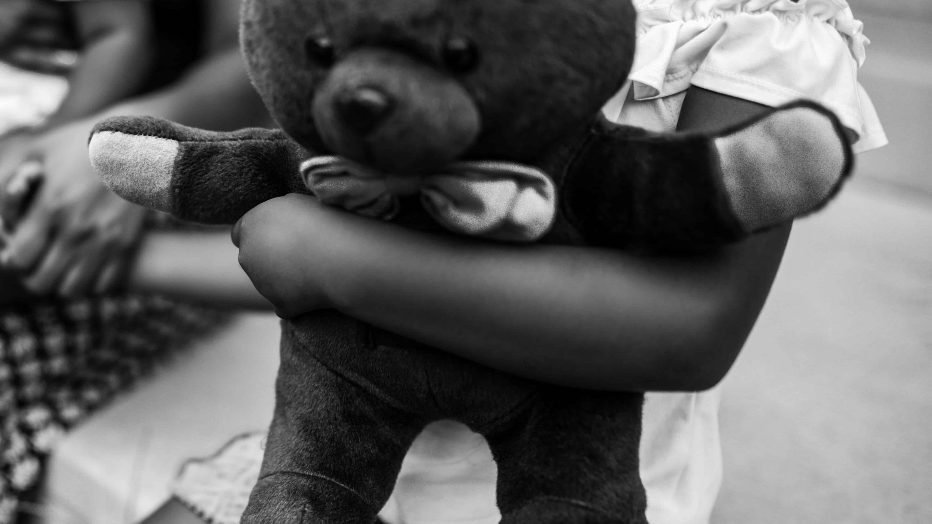 kid holding stuffed animal